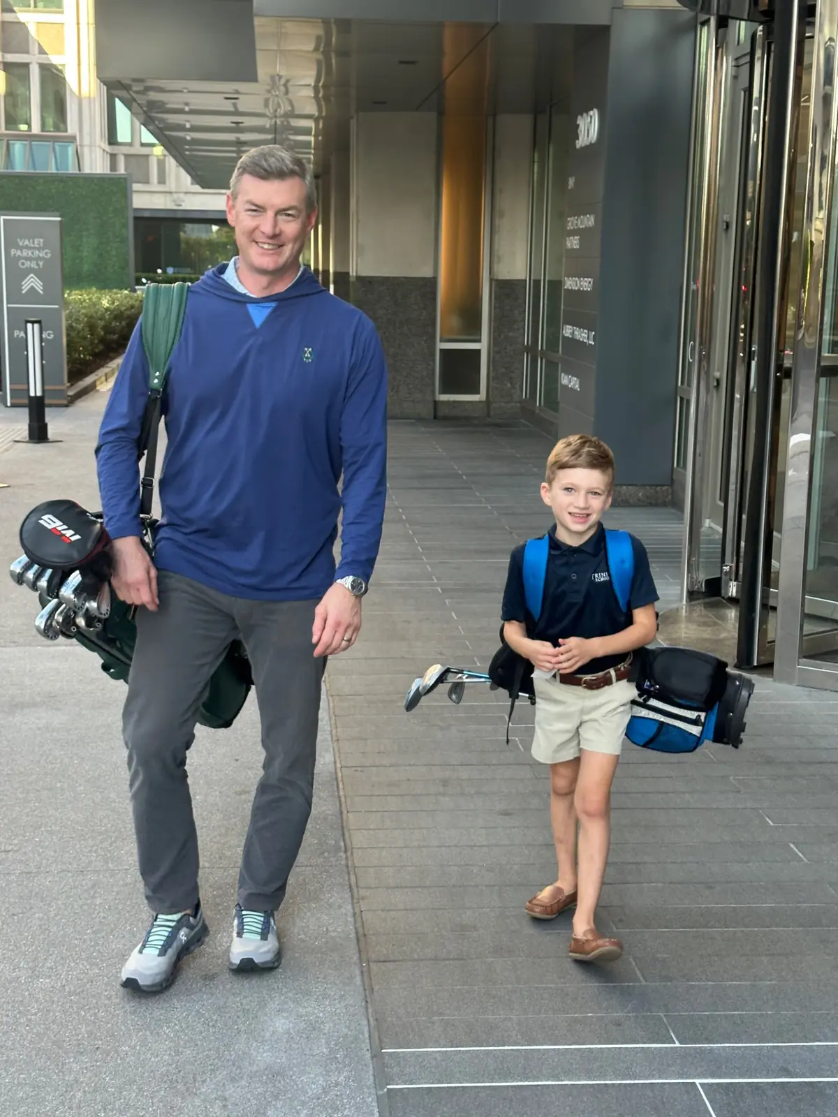 Leo and his dad with golf clubs